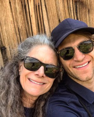 Keegan Allen Instagram - thinking of my mom on her birthday today. The beauty and grace she left remains along with her vacancy. It’s a soft pain I carry silently. But all is temporary except for love.

You don’t need to read the rest, I’m just venting.

It’s weird because it’s been a year, and I have only just begun to mourn. Sometimes it hits me all at once and sometimes it’s a light breeze. I’m still so disoriented in this version of outcome. I know there are so many people grieving different types of losses and grief and it’s complexities challenge us to go deeper into our own existence. 

Everything feels brutally incomplete without her. A deep friendship with my mother pulls me into heaven with her sometimes searching in dreams, listening to the wind, humming through the garden…unable to locate her I just accept reality. Everyone gives solace through quotes and guidances but it’s all a tool that doesn’t fit the job. My life with her was an epic journey, finished too soon. I live for her now but always reaching outside of the barriers.

Today, maybe just for a moment, look around and try and find a place to exist and appreciate that existence. We are all having a human experience, and that’s it. It’s a fleeting thing and we only have the gift of now. 

I miss my mom, absolutely and forever. I know she’s standing on the moon or off on some cosmic adventure. 

Or, maybe she’s finally a little mushroom growing by the stream, her dream. Sweet dreams in a cabin by the fireplace. The scent of red cedar and roses.