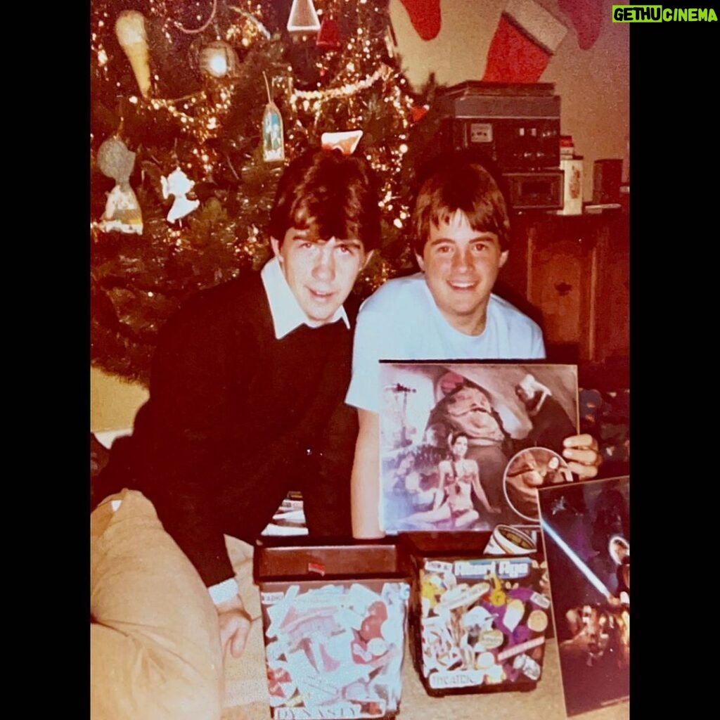 Kevin Smith Instagram - This is what Christmas at 21 Jackson Street in Highlands, NJ looked like 40 years ago, waaaay back in 1983. My sister @virginia_in_vienna made personalized trash cans for me and my brother Donald that year, each covered with collages featuring images of our favorite movies, tv shows and things. I still have mine, though the collage has slipped from its Elmer’s Glue prison and exists apart from the plastic trash can. The tree was artificial and sat in a rotating base that my Mom bought at a Bradlee’s after-Christmas sale in 1978. We had no fireplace so stockings were hung on the wall. Note how happy 13 year old movie nerd Kev is to receive a Return of the Jedi score album. #KevinSmith #christmas