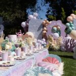 Lala Kent Instagram - I’m still dying over Ocean’s birthday party. I’ve gotten A LOT of messages asking about everything. So here are some pictures and you can find the contacts below 🤍🌊🥳 Photography: @jessicaczarneckicreative Party planners: @picnic_and_petal @glitzandgather Table setting + styling: @picnic_and_petal Balloon installation + styling: @glitzandgather Florist: @lovestruckblooms Acrylic goods: @atomickraftworks Graphic design: @winkandinkpaperie Custom backdrops: @trudesign.contracting Party supplies: @paperandparties Custom party hats + wands: @winnieandhaze Table linens: @cvlinens Custom neon sign: @sketchandetch.neon Cake: @thegateauxshoppe_ Custom macarons + macaron tower: @boymama_bakes Custom sugar cookies: @megans.bakes Candy tray and personalized pouches: @madesweet_byamanda Soft play: @modernkidsplaycompany Mini bounce house: @minicastlesco Custom shirts: @freshbakedteesprintshop Custom bathing suits + trucker hats: @sunnyboutiquemiami Custom Visors + cups: @bubblyandbash Custom sunglasses: @estherbrophoenix Custom air fresheners: @dangle_it Custom can coolers: @carolinacancoolers Custom tissue paper + stickers: @coacousa Custom crayons: @thecrayonclique Custom coloring books: @munchkinlanellc Seashell towels: @shopthemagicbox Coolers: @revocoolers Sparkling water: @sanpellegrino_us @perrierusa Wine: @avaline Venue: @mrjaxtaylor @brittany @littlebabycauchi house
