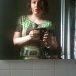 Lena Dunham Instagram - Recently I came across this photo of me at 24. I could remember exactly where I was when it was taken- the bathroom of a bar in the dead heat of August, wearing a vintage dress of my mother's, with this overwhelming feeling (the kind you only get when you're young) that you’re on the precipice of some big change. It got me dreaming about what that girl would have thought if I could appear in that mirror and tell her what the next 10 years would hold. "Hello, it's me, 34 year old Lena. You're not gonna believe this but in, like, 2 months you're going to start on six seasons of a TV show. Are people gonna like it? That's a... complex question, but you will love making it, and you will learn exactly what your own voice sounds like. Oh, and you're going to write books. Like, WHOLE books. And yes, you will fully move out of your parents house and all the way to freakin' California- don't worry, I know it's Hollywood but you won't have to lose weight, in fact you'll gain it- and sometimes even to the UK. And yes, you have a million friends and collaborators you love and you aren't lonely in the ways you are now. Which is good because yeah, you know those random stomach aches? There's, like, a bunch of surgery coming. They're going to take out your uterus, which I know sounds kinda random but trust me, it's a bigger deal once you're older. And then you'll have to get sober. But you don't have a drug problem? Oh, please hold for that. And by the time you're my age you'll have kissed approximately 47 men (you still keep a list!) and literally none of them will be your husband. And you STILL can't fucking drive. But you know the weird part? It's all okay. It's better than okay. It's exactly what you were hoping for when you went into the bathroom and held this brand new thing called an iPhone up to the mirror thinking 'something great is coming.'"