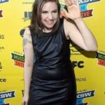 Lena Dunham Instagram - The year: 2009. Obama. Arrested Development on DVD. Babydoll dresses from Urban Outfitters sale racks. I was 23 and couldn’t be stopped (unless my feelings were hurt or I was hungry.) My first film was premiering at SXSW in an afternoon slot. My friends and I were outside a bar on 6th St when a group of boys passed. They were rowdy and loose, with English accents and hair cuts that screamed Meet Me In The Bathroom (plz swipe to understand). I immediately zoomed in on one of them- he was wearing a French military coat, his black hair wild, drunkenly leading the others down the street. He smiled- at me, or in my general direction? I never forgot it- I don’t know why, since I’ve seen a lot of boys, in a lot of places, and very few of them imprinted on me in any real way. But more often than makes sense I’d think back on him- eyes wild, looking like the leader of a band of pickpockets. Over time, the specifics of his face faded from memory. He became an idea, representing something- possibility, freedom, the new life I felt I was forging for myself one badly worn trend at a time. Twelve years later- on Feb 15, 2021, three years ago- I met the person who would become my husband. I’ve said it before, but Lu was immediately familiar to me. I chalked it up to the warm glow of healthy connection. We talked about where we had been, and the places we had in common- including SXSW a few years in a row. Imagine, we said, maybe we’d been dancing in neighboring bars, staying in adjacent motel rooms. A few months later, we packed the last of Lu’s things from his family home in order to start our own. As we weighed what would come with us and what wouldn’t, he pulled a hanger from the closet: “I should throw this out, right? I bought it for tour and wore it every day of 2009. Weird choice.” I looked up. And there it was- the military jacket, long, slim with the gleaming brass buttons, the epaulets. It was him. The beautiful boy. Now, my beautiful boy. Now, a sober adult who walks on the sidewalk. My infinite, swirling companion animal. So nice I married him twice. Sometimes life makes it impossible not to believe. You do the same, Lulu. Gracias, mi amor, por mi vida ❤️
