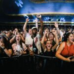 Macklemore Instagram - This tour I have fallen back in love with American venues. I had forgotten. They are sacred spaces that hold energy, stories, secrets, sweat, stained walls, beer riddled floors and stages that have been graced by giants who have come and gone. They are a gathering mecca for the medicine that is music and the magic that occurs in community. Speakers strapped to the ceiling over the heads of humans pressed up against each other screaming the words in unison. It has been life affirming to reconnect to this love. And when I think of venues in America one of my all time favorites is The Rave/Eagles Club in Milwaukee. It is perfect. In stature it is a 200,000 sq ft labyrinth, woven in tapestry’s, hidden hallways, lava lamps, a swimming pool, basketball court, an old bowling alley that was converted to a smaller venue and of course the main room. There is no air conditioning. It is way too hot. It is a place where performers will be tested as will the audience, and I revel in the challenge. The venue is almost 100 years old and is independently owned. Every time I play there I look forward to hearing stories from the owner Leslie who refuses to sell the place to the bigger companies that have attempted to buy it. She is a legend, a friend and a magnificent tour guide of the sprawling oasis. The swimming pool is decorated in graffiti from all the musicians that have stepped foot on this holy ground. I feel my brother Mac’s spirit in this space, as his eerily beautiful words sit beneath the 25 marker of the pool. It is truly a 1 of 1 and makes me proud that my fingerprints are part of its linage. This show marked my 3rd time there and also my 3rd time selling it out. We gave it 100% as always…It just means something more in Milwaukee ❤️ Milwaukee, Wisconsin
