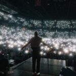 Macklemore Instagram - The Ben Tour USA made its way back home to Washington and a city that I have grown to love over the years: Spokane. It reminds me of Seattle back in the 80’s before IKEA looking condo’s and tech took over. There’s a nostalgic Americana vibe from old brick buildings, wide streets, incredible vintage missions, the Spokane river and rustic diners. Sloane and I put in miles on Lime Scooters riding all over the city and exploring the uncharted terrain. I have classic core memories shooting the Downtown music video when Sloane was a baby and shutting down multiple city blocks to throw a parade with the people of Spokane. That same energy was felt from the moment I stepped into the Spokane Arena. Someone even tracked down the inflatable dog from the music video who made a cameo on stage during Downtown. 11,000 people deep and probably the loudest crowd of the tour. A true Washington homecoming in one of my favorite PNW places ❤️ Spokane, Washington