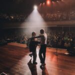 Macklemore Instagram - Nashville was our first stop of THE BEN TOUR USA. I’ve always loved this city. I have an outsiders infatuation with the hole in the wall hot chicken that is way too spicy for my digestive system, the rich lineage of country music that I’ve never listened to and the bars that I don’t drink at. It feels like the most beautiful time warp, an ode to an era of the past. It’s one of my favorite places in the world to go vintage hunting so I spent the day in pursuit of western relics, snakeskin garments and any other come ups the universe would provide. The southern charm is felt in every corner of this city and I felt such a genuine love and excitement from the fans I met before the show waiting in line. Being the first show of the tour I felt a bit nervous beforehand, which is a rare yet welcomed sensation for me these days. The historic, gorgeous and intimate Ryman auditorium is very different than the European festivals we’ve been playing the last 3 months. It’s almost like a different sport, going from massive crowds to intimate ones, but both equal in the opportunity to connect. The Nashville audience was perfectly engaged, turnt and some say they’ve never felt the floor shake like it did last night. Take that Bluegrass. It was extra special last night because my sister Kesha unexpectedly came through 30 seconds before we were about to play Good Old Days and in true Kesha form was down to just hop up on stage and do what she does best… Sing. To round out the Nashville experience after the show a handful of us went next door to the gem that is Roberts to hear the local band and struggle with what y’all call a 2 step. Shit still feels like a waltz count to me, and I eventually returned to the 2 step I learned in middle school to Jodeci. But I respect it. And I love Nashville. Thank you for setting off this tour in the best way possible. Next stop… Our nations capital. Ryman Auditorium Nashville TN