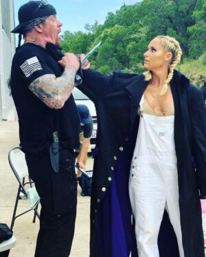 Mark Calaway Instagram - I let @mimicalacool  put the coat on for a second and this happens!! I’m sure you guys can come up with some really good captions.....let’s see what ya got!! #bestcaption #WWE #guzzle #RIP #thelastride #ninelineapparel