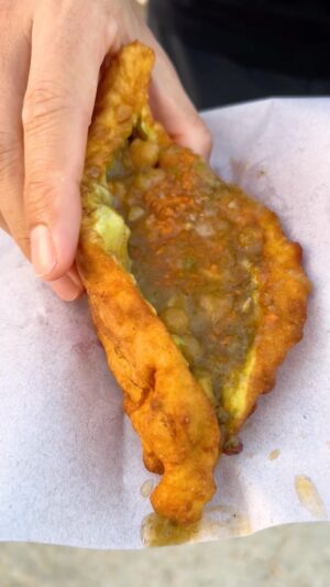 Mark Wiens Instagram - Amazing street food in Trinidad and Tobago 🇹🇹!! One of my favorites, baigan pie - eggplant wrapped in dough, deep fried, then loaded up with curry chickpeas and peppa sauce - happiness. Can’t wait to share the full videos with you, coming soon! Thanks to @booktrinidad #VisitTrinidad and @foodietaleswithzaak #Trinidad #streetfood