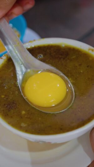 Mark Wiens Instagram - One Indonesian dish that totally blew me away - Pallubasa, a beef or buffalo soup, loaded with grated toasted coconut 🥥, with a raw egg yolk on top. Something you have to eat in #Makassar #IndonesianFood