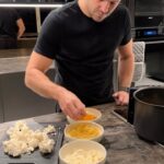 Mark Wright Instagram - Crispy, Parmesan Cauliflower with a Tortilla Crumb. Unreal🔥. Ingredients: (you can adapt this to suit the size of your cauliflower and how much you want to make but the below is based on half of a large cauliflower). - Half a large cauliflower - Half a cup of grated parmesan - 2 eggs, whisked - Handful of salted tortilla chips - 1/2 tsp garlic powder - 1/2 tsp paprika - Salt - Pepper - 1 tbsp mayo - 1 tsp hot sauce Method: 1. Prepare for cauliflower by taking off the leaves, then using a sharp knife cut in half and removing the hard stalk. You’ll be able to easily break the florets into bite size pieces with your hands. Wash then set aside. 2. Whizz your tortilla chips in a blender until crumb like, then add to a small bowl with your spices, salt and pepper. 3. In a second separate bowl whisk your eggs and in a third add your finely grated parmesan 4. Dip each floret into your egg mixture, then the tortilla crumb and finally the parmesan. 5. Air Fry for 15 minutes (turning every 5), meanwhile mix a tablespoon of mayo with some hot sauce for the best dipping sauce!