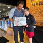 Mike O'Hearn Instagram - What an awesome week in California thanks to @goldsgymvenice1 for your hospitality I cannot describe the feeling looking through @schwarzenegger album with @mikeohearn Two gentlemen I’ve had the privilege of learning from. #greenrangerkyle #bodybuilding #bodybuilder #downsyndrome #downsyndromebodybuilder #emdstigma #fitness #motivation #fyp #fypシ #foryoupage #explorepage Golds Gym Venice Beach