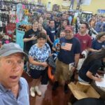 Mike Rowe Instagram – Sunday, outside of @BelAirLiquors there was thunder and lightning and an inch of rain falling every 30 minutes. Inside, there were over 100 well-mannered people with excellent taste in whiskey, waiting patiently in line to shake my hand and grab a photo. What do you say to people who brave a hurricane to say hello and buy a signed bottle of your grandfather’s whiskey? Well, if you’re me, you say “thanks,” as sincerely as you can, over and over again.

Among others was the Pelletier family, all 14 of them. This is the largest family I’ve ever posed for a photo with, and I’m not even sure they were all represented. Once you show up with 14, you have to assume there’s another 3 or 4 in the wings, right? I don’t remember each of their names, but I think it was young Jake (?) who made a crab out of stones, mounted it in a very tasteful frame, and presented it to me as a gift. Thanks, Jake. Very thoughtful. I’ll hang it in a place of prominence upon my return.

I met Nick Berte, who built a very cool Double Whiskey Barrel Liquor Cabinet, that opens and closes with the touch of a remote control. The store is raffling it off at the annual Maryland Italian Festival to raise money for charity.

I met Mike Griffith, who is a Maryland State Delegate for District 35B. I know this because he gave me his business card, which I I’ll hang on to. You never know when you need the services of a state delegate, right?

And then there was Jon, a Baltimore County Detective who was shot four times by a creep with an AR-15 just a few months ago. Jon survived, happily, and was released from the hospital not long ago. His wounds are very serious, but he stood in line like all the others, thanked me for supporting first responders, and gave me a patch that said, “Don’t Die Easy.”

What do you say to a guy who risks his life to serve and protect you, gets damn near killed, and then comes out on a rainy Sunday to shake your hand? If you’re me, you say “thanks,” as sincerely as you can, over and over again.

I proprietor, Larry Dean, and his hardworking family. Big thanks to all of you guys, for making it happen. And congratulations  for having such awesome customers.

Till next time. Belair Md