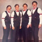 Mike Rowe Instagram - Back in 1984, most of my friends had a porno mustache. I could have grown one myself, I guess, but it wasn’t really my thing. That’s not to say I wasn’t guilty of other dubious fashion statements. Here, for instance, I’m dressed like a black-jack dealer on a break from my duties at The Moulin Rouge. And speaking of rouge, yes, I’m wearing some. As are my old friends, Pat Paul, (porno-stash to my left) and his brother Mike Paul, (porno-stash to his left) and Michael Gellert, (porno-stash to my right.) We were a barbershop quartet called Tyson Street. I won’t even try to explain why four unapologetically virile, masculine men would dress from time to time in matching outfits and slather on pancake and rouge to compete with other male foursomes in elaborate singing contests. But we did, and it was a hell of a lot of fun. This photo was taken after a competition in Pennsylvania where we came in 17th. Funny, I remember thinking at the time that we had a shot at winning. When they announced that we came in 17th, I remember laughing with my mustachioed friends. I miss the days when we could harmonize, not on the stage or in matching outfits, but in a stairwell, or on a street corner, or in a restaurant, where unsuspecting diners were delighted (were they?) to hear us ring out an old chestnut. Or better yet, on a sailboat anchored somewhere in the Chesapeake, where innocent passersby weren't subjected to the sounds of a quartet fueled by a cooler full of beer. There are friendships, and there are friendships held together with beer and close harmony. Those friendships are the best. Mike Gellert turns 70 today. I wish to take this opportunity to acknowledge his dotage. I’m struggling to believe how my old friend can be 70 years old. As always, I’m still nine years younger, but still don’t they go by in a blink? I’m sitting here with my 91-year-old dad this morning, who is doing better every day since his heart attack last week and wondering how quickly the next 30 years will go, if I’m lucky enough to have them. Wish me well, and him, a hell of a happy birthday.