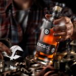 Mike Rowe Instagram - I’ve been delighted, flattered, (and relieved), by the response to Knobel Tennessee Whiskey. My Pop would be proud, and it’s been fun to watch it grow over the last year. These photos were taken by Don Ventre in a factory and a garage in Cincinnati. Funny story… The photos taken in the factory were a total accident. Don was there to photograph a new machine in action, but a critical part didn’t arrive as scheduled. Rather than just sit around all morning, Don grabbed a bottle of Knobel (which he apparently travels with) and set up a few quick shots that will probably win some kind of award. The grinder in the background is pretty great. The stuff in the garage was a bit more deliberate. Every detail, every tool, every shadow and shaft of light was carefully and meticulously designed and styled. I’m not invited to shoots like this, because I lack the patience required for this level of detail and nuance. On Dirty Jobs, we don’t even do second takes but here you can see how a single bottle of whiskey requires the undivided attention of three professional photographers, a stylist, a digitech, and a mechanic who doubled as a hand-model. I also love the fact that this is the garage Don uses in real life, and this is his actual mechanic, Keith Brogan. Big thanks to him, along with Laura Klasamer, Mark Corelli, and Don Ventre for treating photography like the skilled trade it is. Since we now live in a time where the words, “This Bag is NOT a Toy” appear on bags all over the country, I suppose I should say that @KnobelWhiskey should NOT be consumed while operating heavy machinery in a factory, or in a garage while fixing someone’s vehicle. Nor is it intended to be opened with a wrench, as certain idiots might assume the photo implies. As long as I’m pointing out the obvious, I should also tell you that you can still get a bottle for yourself. It really does taste as good as it looks and every online purchase benefits the @mikeroweWORKS Foundation. Finally, and apropos of nothing, the season finale of #DirtyJobs airs tonight at 8PM on @Discovery. I don’t want to say too much, but beavers will be squeezed...More on that, later. Link in bio