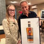 Mike Rowe Instagram - Big thanks to @drug_city_liquors in Dundalk for hosting a Meet and Greet. And an even bigger thanks to the 200 whiskey aficionados who grabbed a photo with yours truly, along with a signed bottle of Knobel Tennessee Whiskey. I was humbled, as always, by your presence, as well as your presents. Consider this cross-stitch from Amanda. Seriously, zoom and look closely at her handiwork. Amanda, aside from being a talented cross-stitcher, is a chemist, and a waitress. She told me that cross-stitching was cool again, and very relaxing. Maybe I’ll try it one day? But probably not, as I am not that cool. Amy Cleaver wanted me to know we might be related. She brought a photo that featured a man she claimed was her Uncle Joe Hergenrather, who also happened to be my second cousin of mine, God rest his soul. Not that I doubted her, but after stopping by my parent’s place and consulting the extensive genealogical tome comprised by my Aunt Betty, it appears Amy was telling the truth. We are in fact related. Proving once again, you never know who you’re going to run into at a whiskey bottle signing. Get a load of Gabe Brooks. Gabe is a former undercover cop in Baltimore who now works for the Bureau of Alcohol, Tobacco, and Firearms. I know this because he gave me an ATF Challenge Coin, and promised to make sure Knobel was properly registered. (It is.) And then there was Bill Pearce. He then presented me with a terrific print from a local artist named Sam Robinson, who captured "The Manor Race," one of the steeplechase races held every year in Monkton, which Bill’s family started 112 years ago. Bill knew my dad was having a birthday tomorrow, and that my mother was crazy for horses. So, he wanted them to have it, and asked me to give it to them with his regards. I did, and they were delighted. A lovely gift, on this, the 63rd anniversary of their nuptials. So many other nice people, with so many stories to tell. Thanks for coming out, very much. If you couldn’t make it, you can order a bottle online, a portion benefits the @mikeroweWORKS. Link in bio. Cheers! Dundalk, Maryland