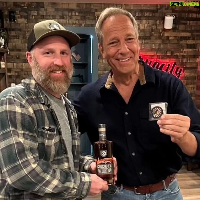 Mike Rowe Instagram - Big thanks to @drug_city_liquors in Dundalk for hosting a Meet and Greet. And an even bigger thanks to the 200 whiskey aficionados who grabbed a photo with yours truly, along with a signed bottle of Knobel Tennessee Whiskey. I was humbled, as always, by your presence, as well as your presents. Consider this cross-stitch from Amanda. Seriously, zoom and look closely at her handiwork. Amanda, aside from being a talented cross-stitcher, is a chemist, and a waitress. She told me that cross-stitching was cool again, and very relaxing. Maybe I’ll try it one day? But probably not, as I am not that cool. Amy Cleaver wanted me to know we might be related. She brought a photo that featured a man she claimed was her Uncle Joe Hergenrather, who also happened to be my second cousin of mine, God rest his soul. Not that I doubted her, but after stopping by my parent’s place and consulting the extensive genealogical tome comprised by my Aunt Betty, it appears Amy was telling the truth. We are in fact related. Proving once again, you never know who you’re going to run into at a whiskey bottle signing. Get a load of Gabe Brooks. Gabe is a former undercover cop in Baltimore who now works for the Bureau of Alcohol, Tobacco, and Firearms. I know this because he gave me an ATF Challenge Coin, and promised to make sure Knobel was properly registered. (It is.) And then there was Bill Pearce. He then presented me with a terrific print from a local artist named Sam Robinson, who captured "The Manor Race," one of the steeplechase races held every year in Monkton, which Bill’s family started 112 years ago. Bill knew my dad was having a birthday tomorrow, and that my mother was crazy for horses. So, he wanted them to have it, and asked me to give it to them with his regards. I did, and they were delighted. A lovely gift, on this, the 63rd anniversary of their nuptials. So many other nice people, with so many stories to tell. Thanks for coming out, very much. If you couldn’t make it, you can order a bottle online, a portion benefits the @mikeroweWORKS. Link in bio. Cheers! Dundalk, Maryland