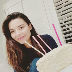 Miranda Cosgrove Instagram - Today was my Birthday. Here’s a picture of me with my half-cake that my Mom made from scratch that was supposed to be a full cake but half got stuck in the pan. I had 5 candles, my mom and dad, and my oldest friend with me. Hope all the other people with quarantine Birthdays have memorable ones too and thanks for all the birthday wishes!