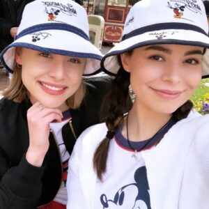 Miranda Cosgrove Instagram - Recreated a pic with @hayleyerin13 at Disneyland. The original picture is from 17 years ago! Trying to bring the bucket hat back 🤣