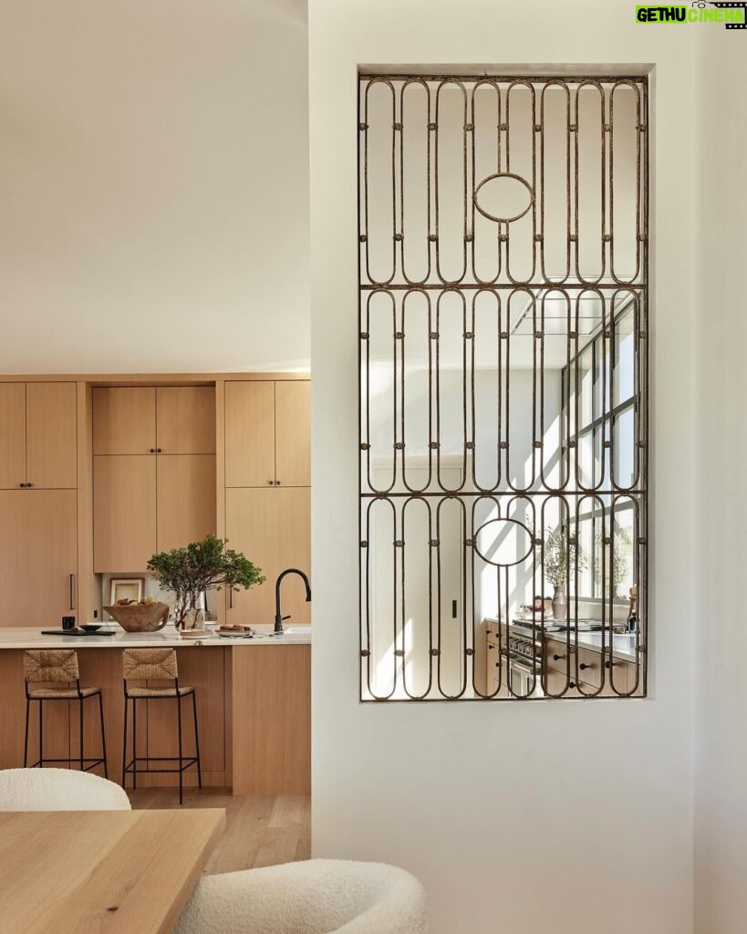 Nate Berkus Instagram - I fell in love with these 1930s French Art Deco garden gates in this desert project that we built into the walls, providing a window-like separation between the kitchen & dining room. It makes it feel like not everything in the house is brand new.