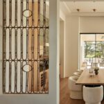 Nate Berkus Instagram – I fell in love with these 1930s French Art Deco garden gates in this desert project that we built into the walls,  providing a window-like separation between the kitchen & dining room. It makes it feel like not everything in the house is brand new.