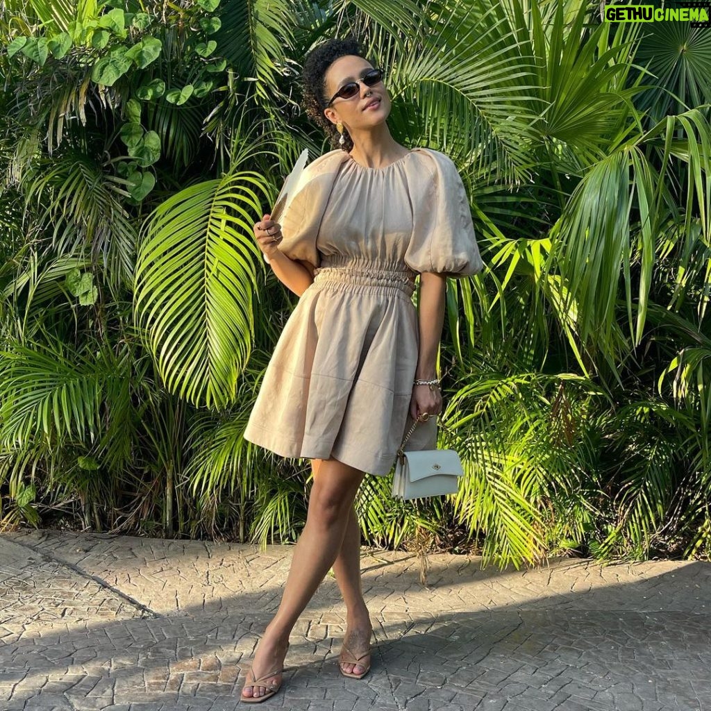 Nathalie Emmanuel Instagram - My wedding lewk for @allymisslove and Andrew’s beautiful wedding at @rwmayakoba. Photo and video skilfully captured by @jd.loveless… he knows the good light honey! Styling by @chercoulter (obvs) Dress: @_aje_ Shoes: @jimmychoo Bag: @metier.london Jewellery: @alighieri_jewellery (a fave ❤️😍) Nose ring: @laura_bond_jewellery Fan: @fernfans_ Sunglasses: @nanushka (🌱💚) #ATimetoRemember #A&A #A♾A #rosewoodmayakoba #Mexico #whoonearthdoIthinkIam🤣 Rosewood Mayakoba