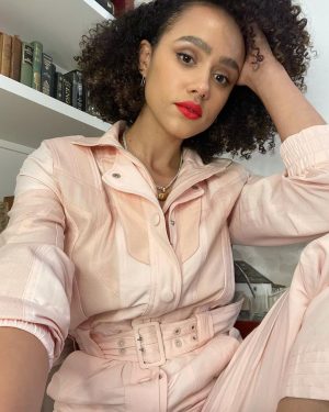 Nathalie Emmanuel Instagram - Virtual press day last week, despite being from my living room, required this fabulous powder pink boiler suit by one of my faves @stellamccartney.. @alighieri_jewellery necklace and @otiumberg earrings… all styled by @chercoulter

Glam by me