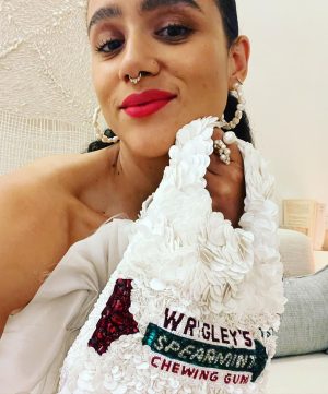 Nathalie Emmanuel Instagram - 🤍MIAMI NIGHT🤍 the night before @allymisslove and Andrew’s wedding… I was so happy I made it… even if it was only for the last hour! 

I had been due to fly a whole day before I did, but because of covid travel restrictions I ended up not being allowed on my flight and had to cancel and rebook whole new flights! But I made it!!!! I got off the plane, went to the hotel, got ready in 30 mins (thanks to my @naturalbabepro ‘Aja’ ponytail) and joined in the festivities to celebrate my lovely friends and their special occasion!

Styled by @chercoulter
Dress: @_aje_ 
Shoes: @casadeiofficial
Bag: @anyahindmarch
Rings: @completedworks
Earrings: @mejuri
Nosering: @laura_bond_jewellery
