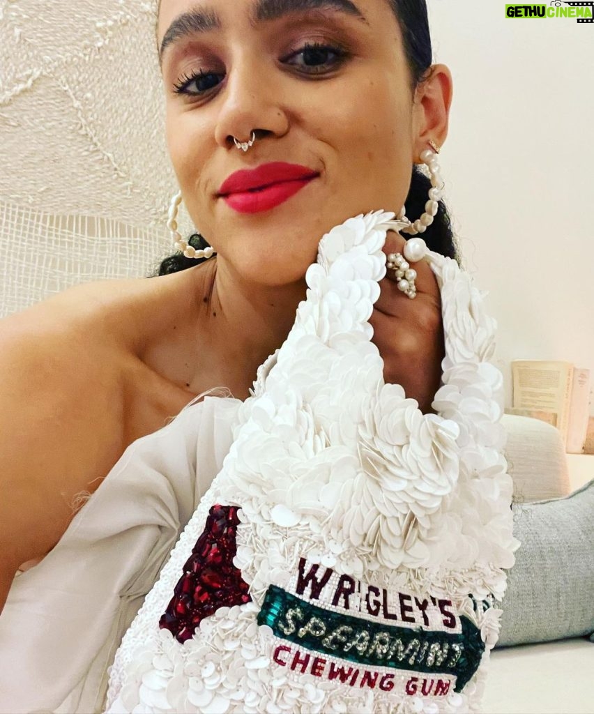 Nathalie Emmanuel Instagram - 🤍MIAMI NIGHT🤍 the night before @allymisslove and Andrew’s wedding… I was so happy I made it… even if it was only for the last hour! I had been due to fly a whole day before I did, but because of covid travel restrictions I ended up not being allowed on my flight and had to cancel and rebook whole new flights! But I made it!!!! I got off the plane, went to the hotel, got ready in 30 mins (thanks to my @naturalbabepro ‘Aja’ ponytail) and joined in the festivities to celebrate my lovely friends and their special occasion! Styled by @chercoulter Dress: @_aje_ Shoes: @casadeiofficial Bag: @anyahindmarch Rings: @completedworks Earrings: @mejuri Nosering: @laura_bond_jewellery Rosewood Mayakoba
