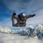 Nirmal Purja Instagram - Heart in the sky. It feels good to be back skydiving with the @skydivenimsdai team. These guys are the best of the best and are creating an experience like no other over the Himalayas. Today we jumped from 23,000ft over the stunning mountains and it felt good to be back under canopy again. There’s nothing quite like the combination of adrenaline and peace that comes from skydiving – the exhilaration of the jump and the peace and tranquillity of the time under canopy, watching the mountains drift by below. We are proud to bring this tandem and solo skydiving experience to our adventure community – combined with the trekking experience which explores the amazing history and culture of Nepal. This is another way of helping to try and grow the economy and tourist offering in Nepal, thereby helping to support the local Big Mountain community in new and sustainable ways that are sympathetic to our home the earth. Some of our jumpers combined this with the @eliteexped Ama Dablam exped. We will be returning to 23,000ft next Spring and Autumn season for more skydiving action, so reach out to the team for more info. #skydiving #freefall #skydivenimsdai #himalayas #eliteexped #nimsdai #14peaks #AmaDablam @skydiveNimsdai #achieveyournewpossible #nothingisimpossible Everest Base Camp