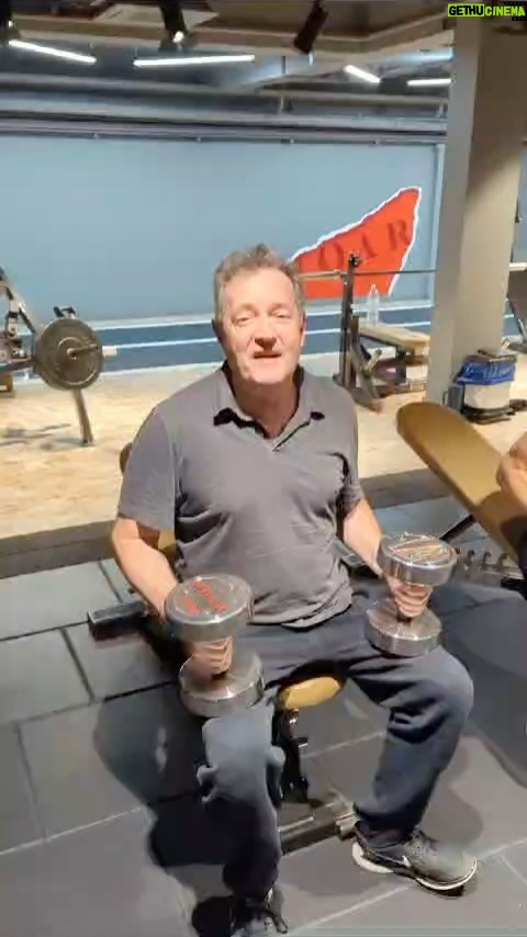 Piers Morgan Instagram - BREAKING NEWS: So, after 3 months of no workouts due to bronchitis, covid, some other weird undiagnosed bug and finally ‘walking pneumonia’…. all of which rendered me a wheezing, coughing, energy-devoid gibbering wreck… I still beat my former Olympian gym boss @roarfitnessgirl in our 17.5kg dumbbell bench press challenge today. 💪🤣 cc @schwarzenegger Roar Classes