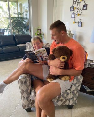 Rob Gronkowski Instagram - That’s my Momma @therealmommagronk instead of reading my elementary books to me, she is now reading her own book she wrote #outnumbered ! My mom is a beast who gets it done!! Grab a copy now on Amazon and learn about her amazing recipe’s and how she managed 5 Boys!! ❤️