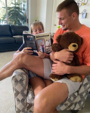 Rob Gronkowski Instagram - That’s my Momma @therealmommagronk instead of reading my elementary books to me, she is now reading her own book she wrote #outnumbered ! My mom is a beast who gets it done!! Grab a copy now on Amazon and learn about her amazing recipe’s and how she managed 5 Boys!! ❤️