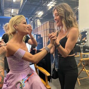 Selma Blair Instagram - About last night…💜

And all the love to @sashafarber1 and my crew of greats✨

IMAGE 1: Selma has short blonde hair and is being lead downstage into the spotlight by her partner Sasha who has short brown hair and is wearing a lavender suit.

IMAGE 2 : Selma has short blonde hair and is seated in a chair in wearing a long lavender dress while she looks to the left and holds hands with Amy, who has dark blonde hair and is wearing black pants and a black top.

IMAGE 3: Selma stands in a lavender dress with her friends Jamie, Andraéa, Hylda, her son Arthur and Jason.

IMAGE 4: Selma has short blond hair and is standing with her arm around her son Arthur, who is wearing a navy jacket.

IMAGE 5 - Selma and Sasha hug on stage at the end of their performance.