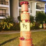 Swasika Instagram - 8 tier Royal wonder for Swasika’s wedding reception When Swasika contacted me 4 months before her wedding, I had no idea that I would be making something like this for her. All she wanted was something Red, Elegant & Royal. And from there the discussions started and ended with this 8 tier beauty! The look on Swasika’s face when she saw her cake was worth all the effort I put into it… The entire cake was covered in fondant. The red colour was particularly customised and hand rolled to suit her liking. The beige square tier was a last minute addition inspired by her wedding saree blouse. Each tier was meticulously stencilled with Royal icing and hand painted gold. I added fondant accents to enhance the overall look. The entire look was completed with a custom acrylic topper that included the bride and groom’s initials and some flowers . . The cake design was inspired by @indulgencebyshazneenali and @cakestrybyfathimaiqbal wedding cakes RECCAA Club