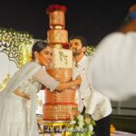 Swasika Instagram - 8 tier Royal wonder for Swasika’s wedding reception When Swasika contacted me 4 months before her wedding, I had no idea that I would be making something like this for her. All she wanted was something Red, Elegant & Royal. And from there the discussions started and ended with this 8 tier beauty! The look on Swasika’s face when she saw her cake was worth all the effort I put into it… The entire cake was covered in fondant. The red colour was particularly customised and hand rolled to suit her liking. The beige square tier was a last minute addition inspired by her wedding saree blouse. Each tier was meticulously stencilled with Royal icing and hand painted gold. I added fondant accents to enhance the overall look. The entire look was completed with a custom acrylic topper that included the bride and groom’s initials and some flowers . . The cake design was inspired by @indulgencebyshazneenali and @cakestrybyfathimaiqbal wedding cakes RECCAA Club