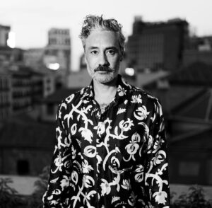 Taika Waititi Instagram - Followed this chick around Madrid while she sang in a palace for @cartier. Thank you, Universe, for this sweet life and also thank you @nanushka for the silkies. damn your clothes are nice. 
Stylez: @jeanneyangstyle 
📸: @tiziano.raw