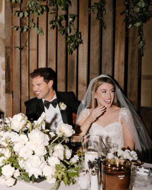 Taylor Lautner Instagram - COCKTAIL HOUR/RECEPTION
After the ceremony, guests were shuttled back down from the vineyard to the tasting room where they toasted one another with a glass of Casamigos cocktails named after our dogs Remi and Lily, and a variety of wines from Epoch. Live music was played on a grand piano covered in overgrown florals, and bottles of Epoch’s Rose were being live painted for guests to take home at the end of the night as a keepsake. Hundreds of Edison bulbs hung from the stunning trees over the cocktail bar, grand piano and live bottle painting station. On their way to the reception area, guests walked through a butterfly garden filled with greenery. There, butterflies floated amongst guests while a harpist played in the background. Once inside, there were candles from Snif burning a custom scent called “Sweet Ash” and leather menu books embossed with a custom TT logo at each place setting. We both attach smells to memories and people so we wanted to have a specific “scent” to our wedding that guests walked away resonating it to. We felt including this unique logo of two T’s intertwined (designed by our planner/designer Josiah) on just about every part of the day would make it feel special. Greenery and white florals filled the room to contrast the sexy industrial look of the tasting room. Did someone say more Edison bulbs? Yes, we did. Hanging Edison bulbs lined the three rows of tables we had for our loved ones. After our three course dinner paired with Epoch’s wines concluded everyone was ushered back outside surrounding the grand piano where our good friend and boy Tay’s groomsmen Aodhan King performed our first dance live. Aodhan and our other close friend Ben Hastings were gracious enough to lend us their beautiful voices for a few more songs until it was time to party. Low flying dry ice fog started to escape under the tasting room doors to outside inviting people back into a completely flipped dance floor that would take our souls for the rest of the evening. What’s a wedding without a dance floor, a few spilled drinks and the brides mother actually taking a nasty spill on it ;) (true story, rip to her kneecaps)