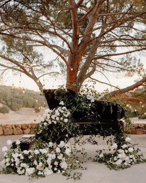 Taylor Lautner Instagram - COCKTAIL HOUR/RECEPTION
After the ceremony, guests were shuttled back down from the vineyard to the tasting room where they toasted one another with a glass of Casamigos cocktails named after our dogs Remi and Lily, and a variety of wines from Epoch. Live music was played on a grand piano covered in overgrown florals, and bottles of Epoch’s Rose were being live painted for guests to take home at the end of the night as a keepsake. Hundreds of Edison bulbs hung from the stunning trees over the cocktail bar, grand piano and live bottle painting station. On their way to the reception area, guests walked through a butterfly garden filled with greenery. There, butterflies floated amongst guests while a harpist played in the background. Once inside, there were candles from Snif burning a custom scent called “Sweet Ash” and leather menu books embossed with a custom TT logo at each place setting. We both attach smells to memories and people so we wanted to have a specific “scent” to our wedding that guests walked away resonating it to. We felt including this unique logo of two T’s intertwined (designed by our planner/designer Josiah) on just about every part of the day would make it feel special. Greenery and white florals filled the room to contrast the sexy industrial look of the tasting room. Did someone say more Edison bulbs? Yes, we did. Hanging Edison bulbs lined the three rows of tables we had for our loved ones. After our three course dinner paired with Epoch’s wines concluded everyone was ushered back outside surrounding the grand piano where our good friend and boy Tay’s groomsmen Aodhan King performed our first dance live. Aodhan and our other close friend Ben Hastings were gracious enough to lend us their beautiful voices for a few more songs until it was time to party. Low flying dry ice fog started to escape under the tasting room doors to outside inviting people back into a completely flipped dance floor that would take our souls for the rest of the evening. What’s a wedding without a dance floor, a few spilled drinks and the brides mother actually taking a nasty spill on it ;) (true story, rip to her kneecaps)