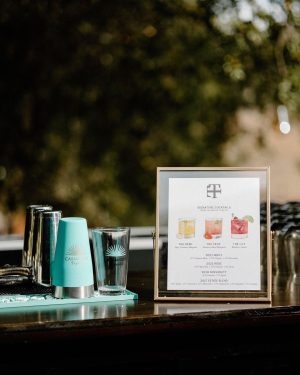 Taylor Lautner Instagram - COCKTAIL HOUR/RECEPTION
After the ceremony, guests were shuttled back down from the vineyard to the tasting room where they toasted one another with a glass of Casamigos cocktails named after our dogs Remi and Lily, and a variety of wines from Epoch. Live music was played on a grand piano covered in overgrown florals, and bottles of Epoch’s Rose were being live painted for guests to take home at the end of the night as a keepsake. Hundreds of Edison bulbs hung from the stunning trees over the cocktail bar, grand piano and live bottle painting station. On their way to the reception area, guests walked through a butterfly garden filled with greenery. There, butterflies floated amongst guests while a harpist played in the background. Once inside, there were candles from Snif burning a custom scent called “Sweet Ash” and leather menu books embossed with a custom TT logo at each place setting. We both attach smells to memories and people so we wanted to have a specific “scent” to our wedding that guests walked away resonating it to. We felt including this unique logo of two T’s intertwined (designed by our planner/designer Josiah) on just about every part of the day would make it feel special. Greenery and white florals filled the room to contrast the sexy industrial look of the tasting room. Did someone say more Edison bulbs? Yes, we did. Hanging Edison bulbs lined the three rows of tables we had for our loved ones. After our three course dinner paired with Epoch’s wines concluded everyone was ushered back outside surrounding the grand piano where our good friend and boy Tay’s groomsmen Aodhan King performed our first dance live. Aodhan and our other close friend Ben Hastings were gracious enough to lend us their beautiful voices for a few more songs until it was time to party. Low flying dry ice fog started to escape under the tasting room doors to outside inviting people back into a completely flipped dance floor that would take our souls for the rest of the evening. What’s a wedding without a dance floor, a few spilled drinks and the brides mother actually taking a nasty spill on it ;) (true story, rip to her kneecaps)