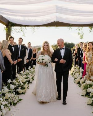 Taylor Lautner Instagram - CEREMONY
The ceremony was something we’ve been dreaming of for a long time. Along with the help of our wedding planners, we put in a lot of thought designing what exactly we wanted for this monumental moment and it came together even better than we had imagined. The ceremony location was at one of the highest points on the Epoch property which overlooks miles of wine country in Paso Robles. The colors surrounding us at this time of year are exactly why we love the Fall season so much. In an effort to provide shade and intimacy we installed a wooden truss system and semi sheer white draping, to create a relaxing and partially shaded ceremony location. White florals and lush greenery trailed up the columns of the wooden
structure and down the ceremony aisle. Beautiful white floral blooms surrounded us on a circle riser stage. As guests arrived by shuttle, they were invited to take a walk through the vineyard to the ceremony site. Our pastor and dear friend Judah Smith officiated the ceremony. It couldn’t have been more perfect. We exchanged hand written vows in front of the people we love most. Looking around and seeing the faces of each and every single person there, really put into perspective what is most important in life. Love. The sun set just as we said our “I Do’s” and the most beautiful pink sky was our backdrop as we walked back down the aisle as Mr. and Mrs. Taylor Lautner for the first time. 

Planning and Event Design @samkoma.world
Venue @epochwines
Photography @nicoleivanovphoto
Lighting @tn_event_designs
Floral Design @noonansdesigns 
Wedding Dress @winniecouture 
Grooms Tux @dolcegabbana