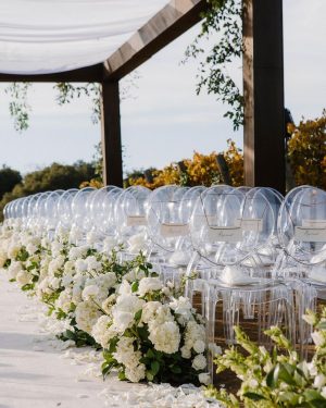 Taylor Lautner Instagram - CEREMONY
The ceremony was something we’ve been dreaming of for a long time. Along with the help of our wedding planners, we put in a lot of thought designing what exactly we wanted for this monumental moment and it came together even better than we had imagined. The ceremony location was at one of the highest points on the Epoch property which overlooks miles of wine country in Paso Robles. The colors surrounding us at this time of year are exactly why we love the Fall season so much. In an effort to provide shade and intimacy we installed a wooden truss system and semi sheer white draping, to create a relaxing and partially shaded ceremony location. White florals and lush greenery trailed up the columns of the wooden
structure and down the ceremony aisle. Beautiful white floral blooms surrounded us on a circle riser stage. As guests arrived by shuttle, they were invited to take a walk through the vineyard to the ceremony site. Our pastor and dear friend Judah Smith officiated the ceremony. It couldn’t have been more perfect. We exchanged hand written vows in front of the people we love most. Looking around and seeing the faces of each and every single person there, really put into perspective what is most important in life. Love. The sun set just as we said our “I Do’s” and the most beautiful pink sky was our backdrop as we walked back down the aisle as Mr. and Mrs. Taylor Lautner for the first time. 

Planning and Event Design @samkoma.world
Venue @epochwines
Photography @nicoleivanovphoto
Lighting @tn_event_designs
Floral Design @noonansdesigns 
Wedding Dress @winniecouture 
Grooms Tux @dolcegabbana