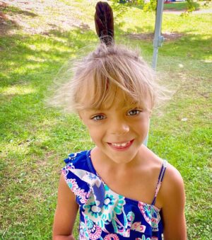Tyler Baltierra Instagram - I found this feather while we were camping & Novalee just had to have it in her hair lol it made her so happy & she felt so pretty! I can’t believe she is starting Kindergarten this year. Like how did this happen so fast!? One day I’m rocking her to sleep listening to her little baby snores on my chest & the next day she’s off on a bus like a big kid. But no matter how old she gets, I will always cherish the moments spent putting a smile on that beautiful face! 😍❤️😭 #NovaleeReign