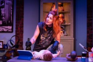 Emily Bett Rickards Instagram - This here is Kelly and I am fortunate to get to bring her to life tonight at the @sohoplayhouse 🤘🏼Zayd Dorhns Reborning is a wild rollercoaster that @loritriolo @paul.piaskowski and I are currently riding. Tonight we officially open!!! 💥 This has been an experience of a lifetime. 👶🖤🧡🖤👶
