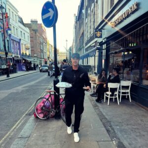 Paddy McGuinness Instagram - Casually strolling through Soho with my roast dinner to go! Extra cool points for cutlery in the top pocket vibes. Very late finish last night on Don’t Look Down for @su2cuk This resplendent takeaway helped on the journey home. Cheers to The Crown and Two Chairmen. 😋 #sunday #roast