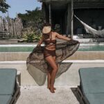 Pearl Thusi Instagram - Brown sugar babe… 🍯🍹🧉 Shades & sun hat : @karllagerfeld @preview_designer_collection Azulik Private Lodge, Mozambique