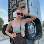 Polina Pushkareva Instagram - Conclusions on Coachella 2023: the guide on how to survive Coachella is a challenge. You're trying to chill and enjoy the atmosphere, music, dating, but it's very hard to be in the desert. Wanna share my thoughts after the fest and what I will do next year. 1.Wear only gathered hairstyles and fix them well with hairspray. The wind is fuckingly strong, so the loose hair quickly turns into a nest. 2. Always carry a lipstick with you to quickly fix your makeup. If you can do without any lipstick, it's even better. Plus, dust sticks on the lipstick which is quite unpleasant. 3. Wear cool and not super comfortable outfits for photo shoots in the desert. And it’s better to go to the festival in comfortable clothes, in which you can spend the whole night. 4. The face mask is a must-have. Be sure to take a backpack with you (not just a beautiful handbag) and put into it antihistamines, medicines for stomach and any other pills that you may need. Anything can happen in the desert, and the medical center is not always nearby. 5. Live alone and meet friends at the festival. That's perfect. You can wake up and fall asleep whenever you want, do whatever you want and not adapt to other people's plans. 6. Come to the festival by 7 p.m. Unless, of course, someone you love performs during the day. After 5 hours there you get so tired that you don't enjoy it anymore. And the top artists start performing in the evening. 7. Take a tripod. I took all the photos in this trip myself. I just put the camera and posed as much as I wanted. If content is your priority, take a tripod, set aside one hour and calmly shoot yourself in different locations. Btw, which outfit do you like most of all? Coachella, California