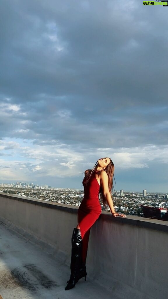 Savannah Clarke Instagram - T H E W E S T S I D E __________________________________ A sunflower soul With rock and roll eyes Curious thoughts & a heart of surprise ____________________________________ #LookToThePositive #Optimistic #arianagrande #PositiveVibes #RedDress #RoofatopViews #VideoGram #SunSets #GoldenHour #LongBoots #CityViews #RoofTop #LAVibe #california ____________________________________ Los Angeles, California