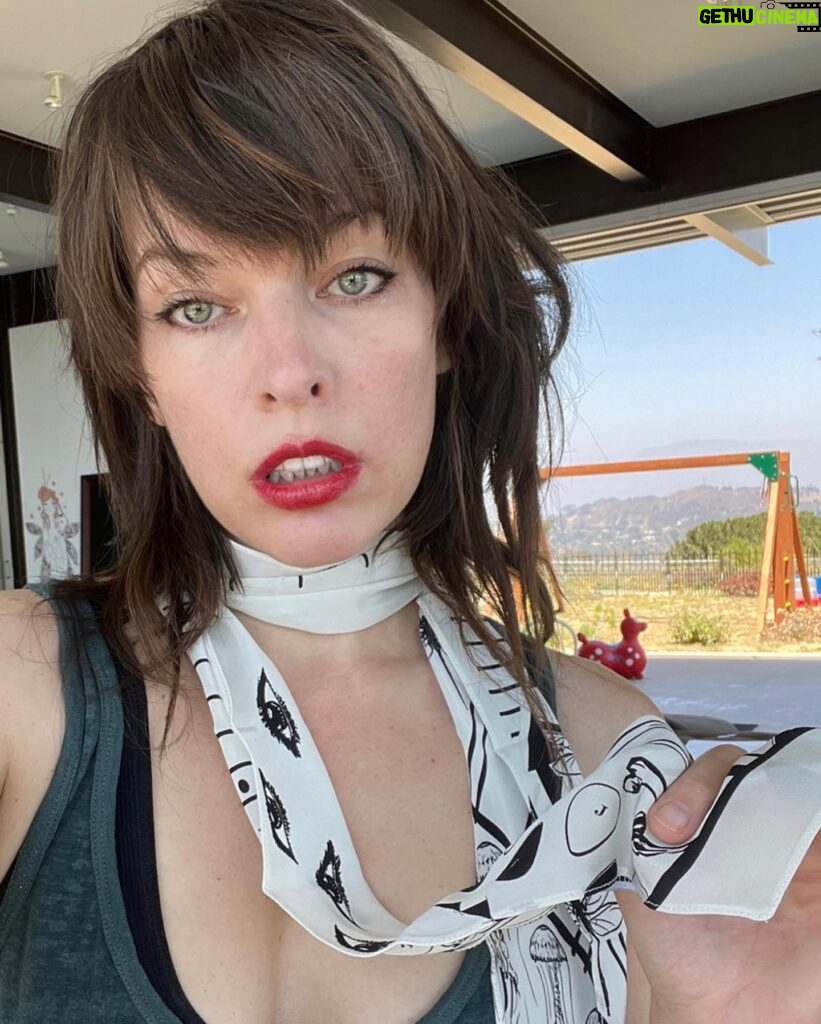 Milla Jovovich Instagram - On a lighter note, I wanted to give a big shout out to the incredible @stizzyho for my awesome new haircut and @sassysio for the beautiful color!! Also, just got these mouth watering new skinny scarves from @rockinshq and I’m loving the new lewk!!❤️‍🔥💋💅🏼