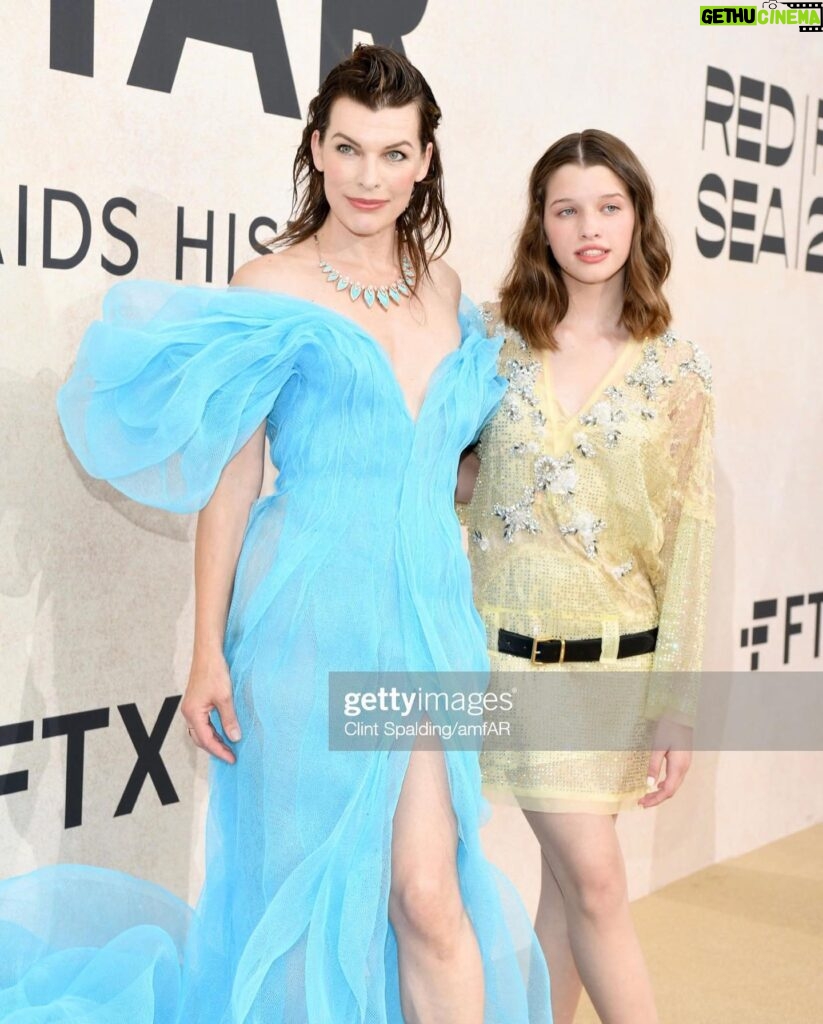 Milla Jovovich Instagram - Thank you @amfar for being a ray of light in this dark world right now. I am so proud to support all the incredible break throughs in medicine that this organization has made possible over the years through their fund raising for people living with HIV/AIDS as well as raising awareness for the prevention of the disease. I was lucky enough to be dressed for the gala by my fellow Ukrainian, the incredible designer @lever_couture! Together, my daughter @everanderson and I completed the Ukrainian flag with our colors on the red carpet! A special thank you to @messikajewelry and my amazing glam team: make up @patidubroff and hair @cyrillaloue!