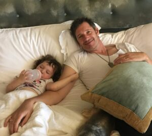 Milla Jovovich Instagram - Happy Father’s Day to our most incredible Papa!! Here’s a little recap of your journey to being the best daddy in the world! It feels like you were really meant to be a dad. You always took such great care of me, the “big baby”😂 and you naturally added Thing 1, 2 and 3 into the mix over the last 15 years. Everyday I am amazed and in awe of how gentle, kind and attentive you are to each and every one of us. The hours you’ve spent making thousands of bottles of milk for the babies, the same amount of cups of tea for me, doing math homework, building legos, playing dolls, Uno, Dungeons and Dragons, building cars, buses and rocket ships out of card board boxes, getting your nails done in rainbow colors, getting your hair and make up done, getting vomited on (and worse) god knows how many times and all with a great big smile though it all. You make it look easy when I know it’s anything but. You are our EVERYTHING. We would be lost without your love, time and energy because it seems boundless and the well never seems to run dry. You truly are the most amazing daddy. To all your babies. Big and small. I love you Papa.❤️❤️❤️ You’re the ultimate KING👑!!! #paulwsanderson #fathersday #iloveyou