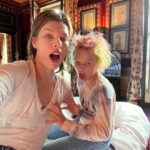 Milla Jovovich Instagram - Oui Oui Baguette! The Jovovich-Anderson Clan sans bébé have arrived in Paris pour fashion week! Well, actually @everanderson is the only one who’s actually doing fashion week stuff and the rest of us are just hangers on, mooching off our eldest✊😂🥳 Thanks Evs, @veesback @chrissbrenner and @miumiu for this amazing family trip!🥰🥰🥰