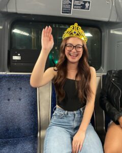 Anna Cathcart Instagram - happy_girl_with_tiara_on_bus.JPEG